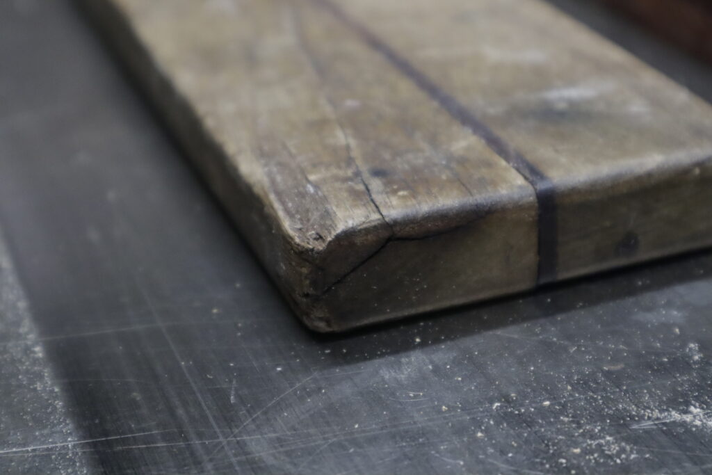 Detail of a large split on one corner of the board.